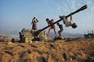 Make-believe conquers the tools of war as Muslim children clamber over an abandoned antiaircraft gun.  Discarded shells around the gun may still be live, like the explosive grievances and vengeance harbored  by many of Beirut's factions.  Will there at la